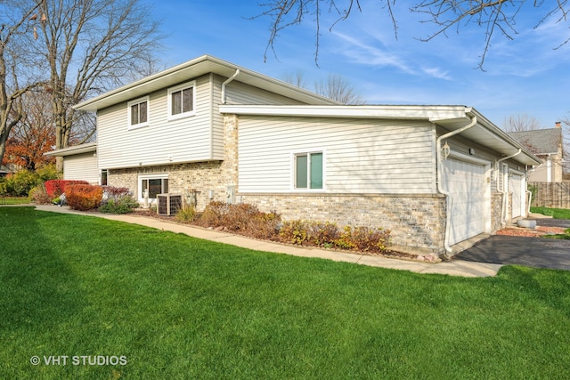 view of home's exterior featuring a lawn, central AC unit, and a garage