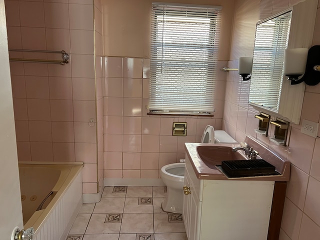 bathroom featuring tile patterned flooring, vanity, and tile walls