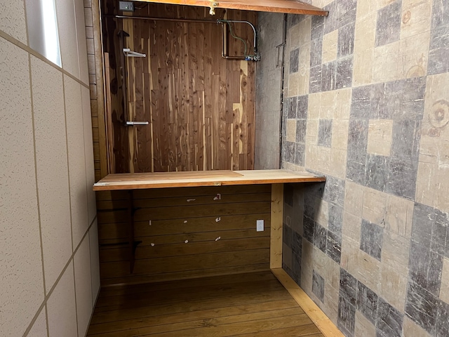 walk in closet with wood-type flooring