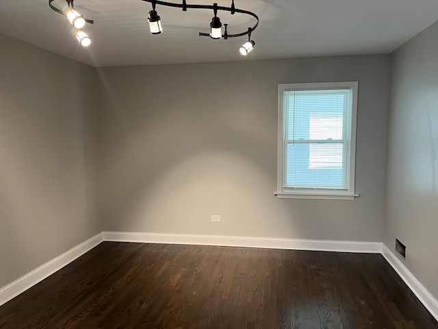 empty room with dark hardwood / wood-style flooring