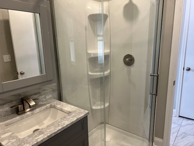 bathroom with a shower with door and vanity