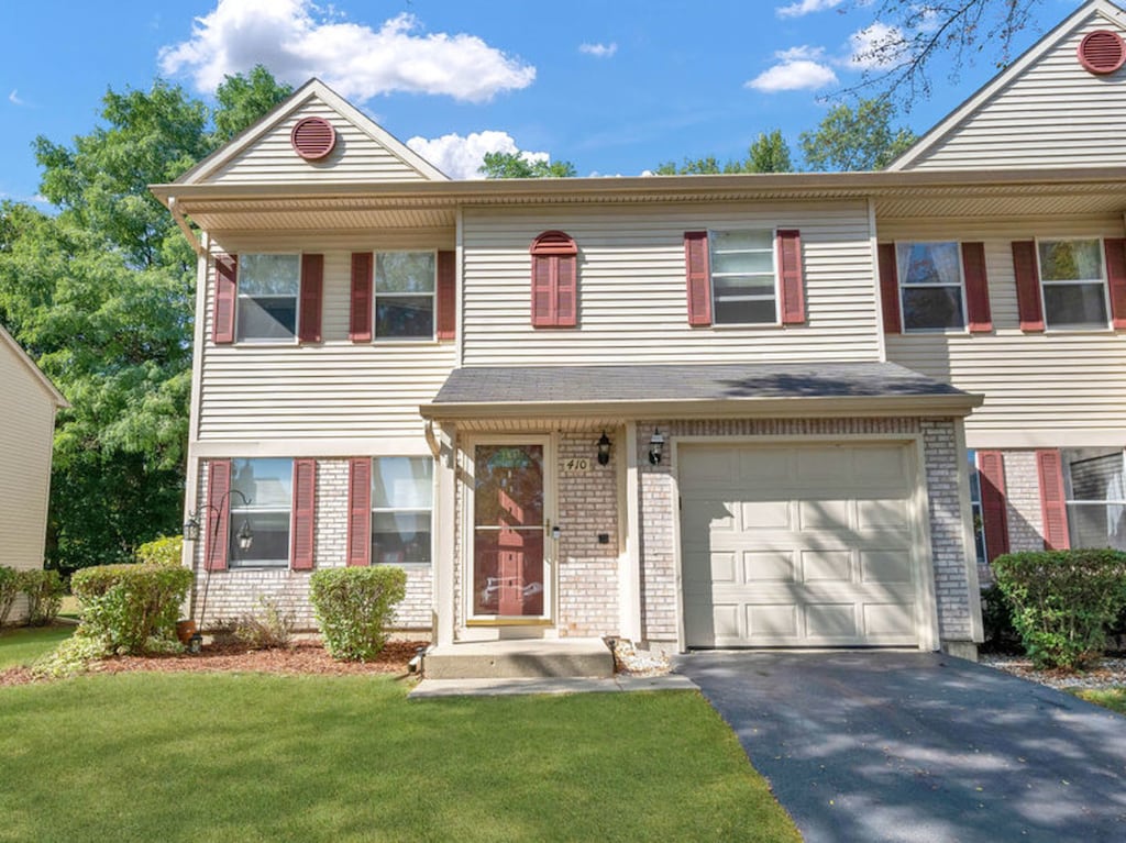 view of front of property with a garage and a front lawn