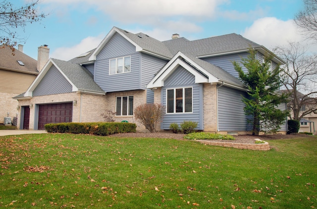 view of front of house featuring a front lawn and a garage