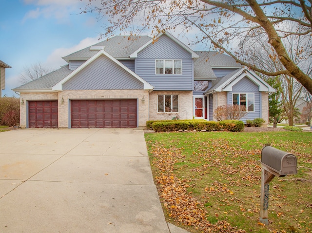 view of front facade with a garage and a front lawn