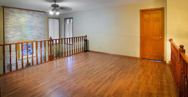 unfurnished room with hardwood / wood-style floors and ceiling fan