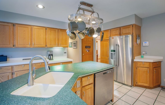 kitchen featuring sink, light tile patterned floors, and appliances with stainless steel finishes