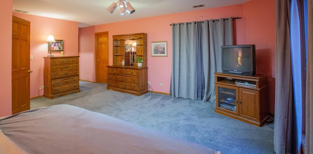 bedroom featuring light colored carpet and ceiling fan