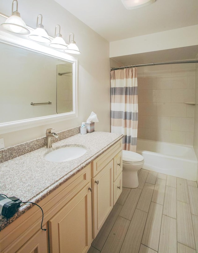 full bathroom with shower / tub combo, vanity, and toilet