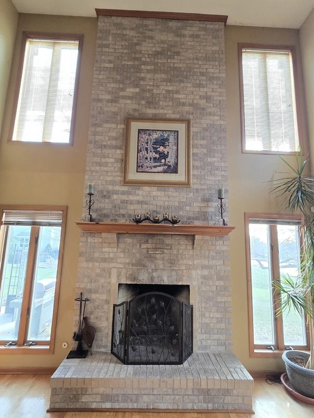 living room featuring light wood-type flooring and a brick fireplace