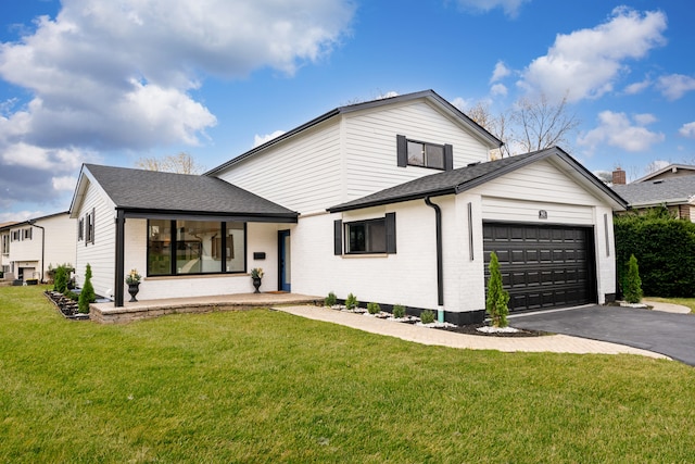 modern farmhouse with a front lawn, a porch, and a garage