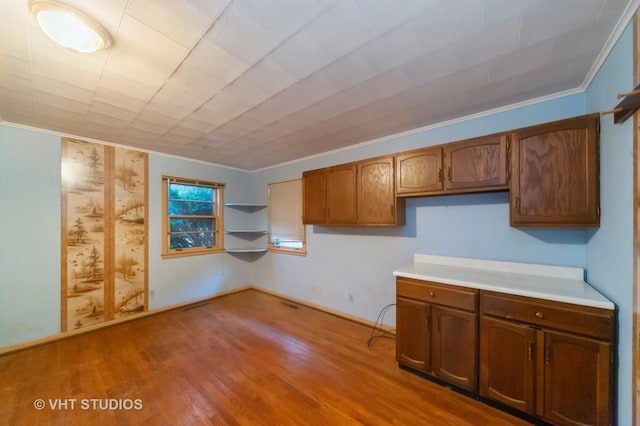 kitchen with light hardwood / wood-style floors and crown molding