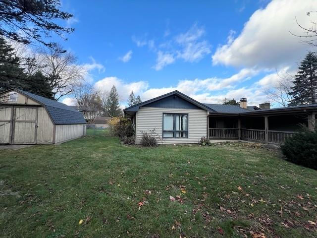 exterior space featuring a shed and a lawn