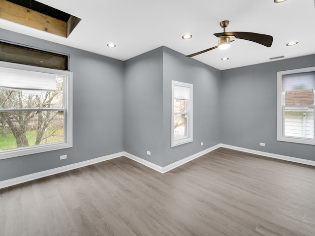 empty room with hardwood / wood-style flooring and ceiling fan