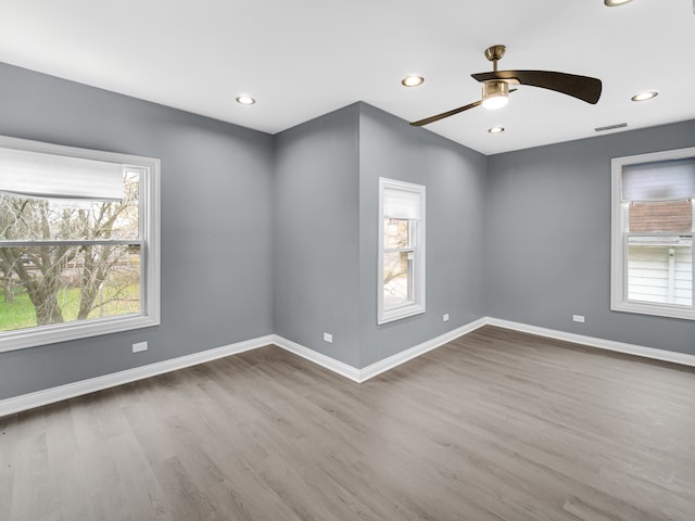 empty room with hardwood / wood-style flooring and ceiling fan