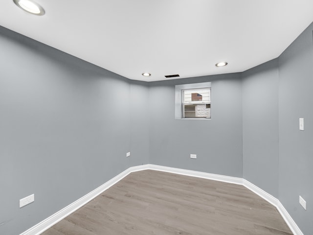 basement with hardwood / wood-style flooring