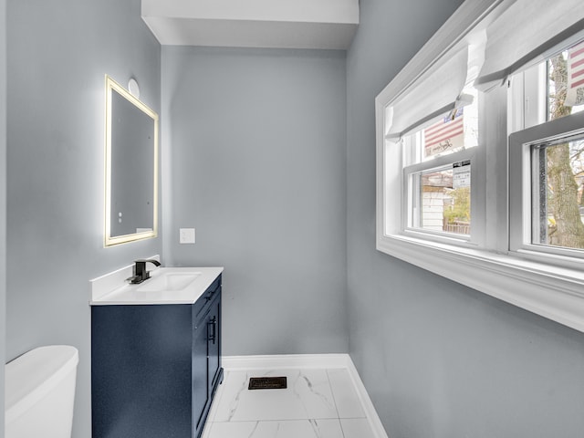 bathroom featuring vanity and toilet