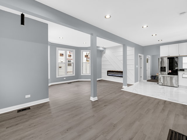 unfurnished living room featuring light hardwood / wood-style flooring