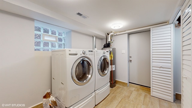 laundry room featuring light wood-type flooring and washing machine and clothes dryer