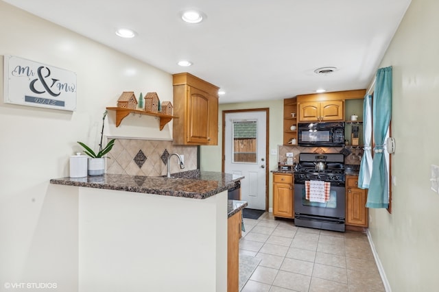 kitchen with black appliances, dark stone countertops, kitchen peninsula, and backsplash