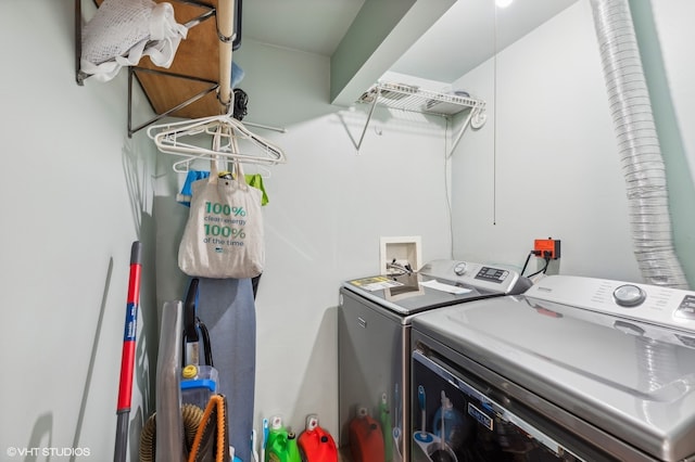 clothes washing area with washing machine and clothes dryer