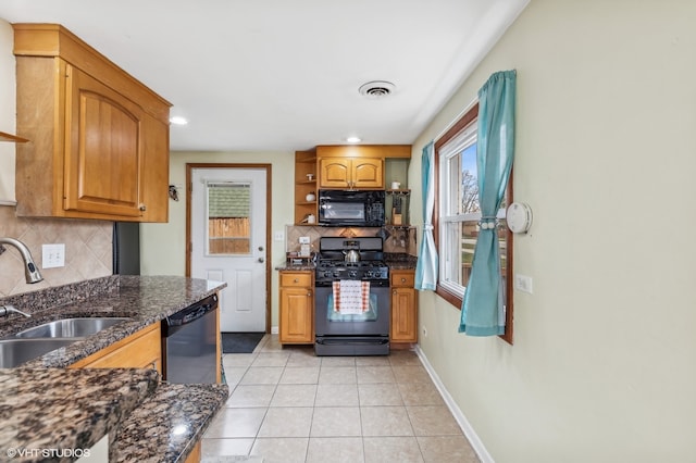 kitchen with backsplash, sink, black appliances, dark stone countertops, and light tile patterned flooring