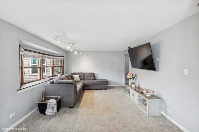 carpeted living room with track lighting