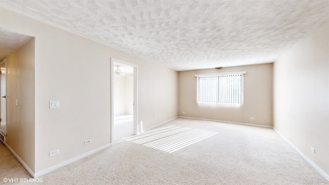 unfurnished room with light carpet, a textured ceiling, and ceiling fan