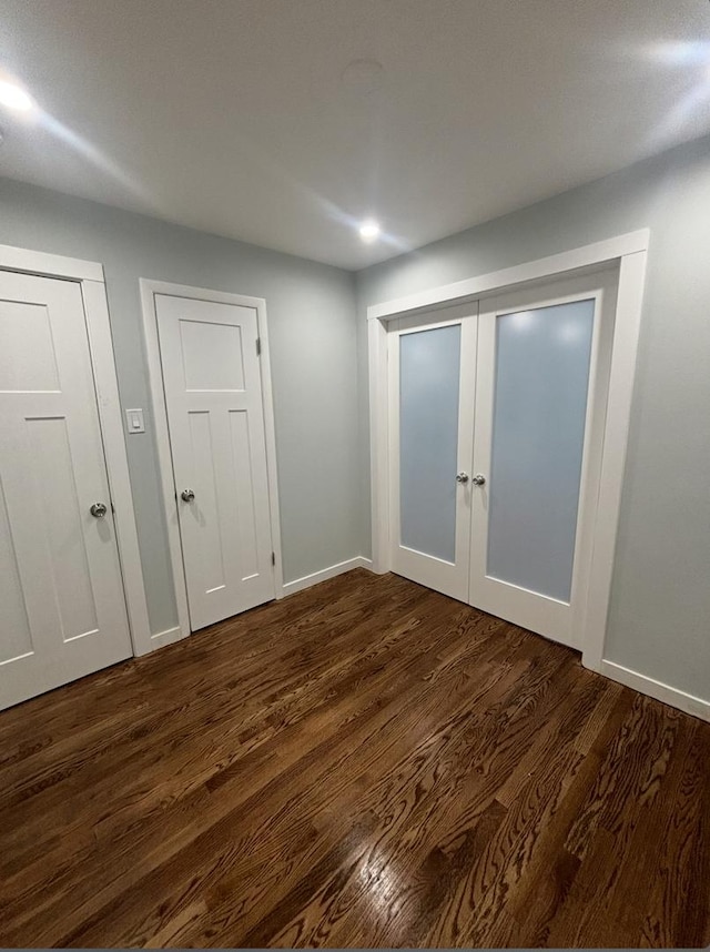 unfurnished bedroom featuring dark hardwood / wood-style flooring