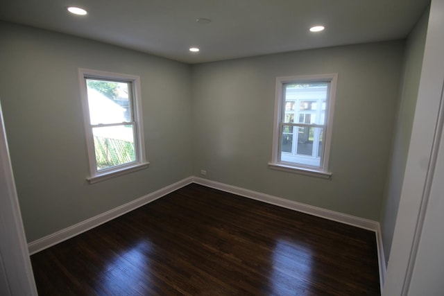 unfurnished room featuring dark wood-type flooring