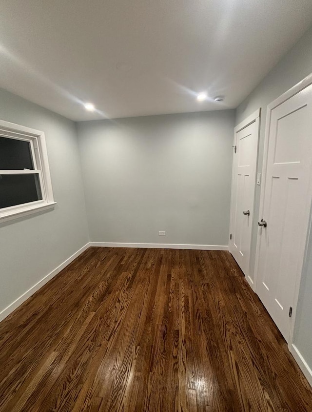 spare room with dark hardwood / wood-style floors