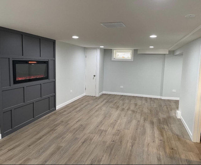 basement with dark hardwood / wood-style flooring