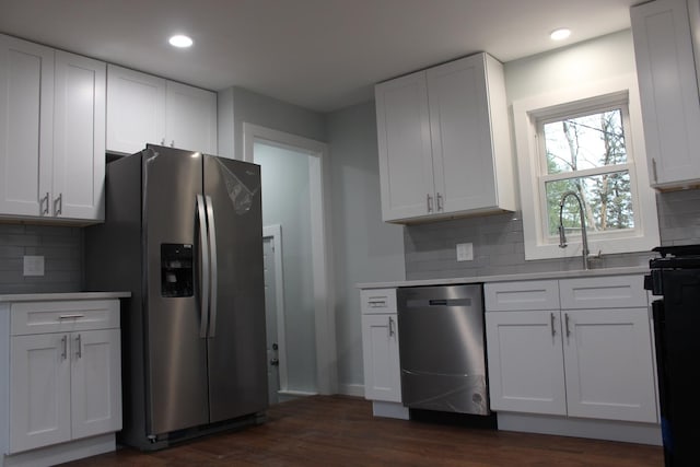 kitchen featuring white cabinets, tasteful backsplash, and sink