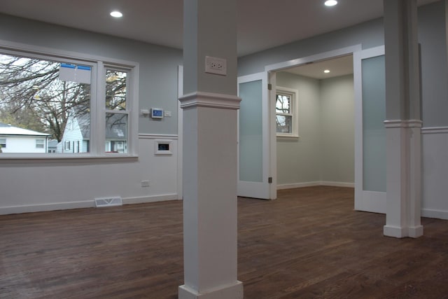 foyer entrance featuring a healthy amount of sunlight and dark hardwood / wood-style floors