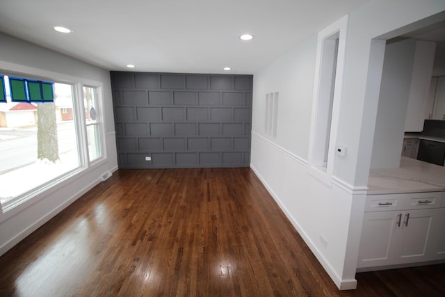 unfurnished room with dark wood-type flooring