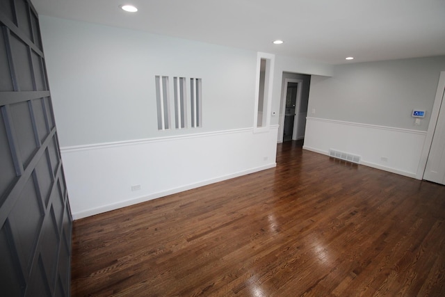 unfurnished room with dark hardwood / wood-style flooring