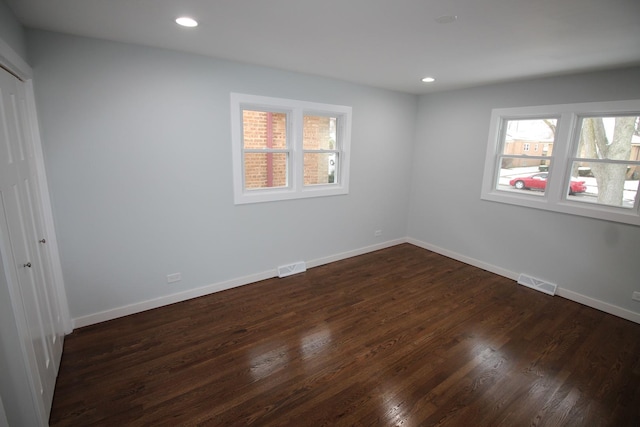 spare room with dark hardwood / wood-style flooring