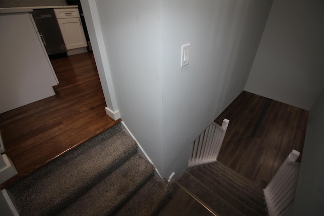 stairway with hardwood / wood-style flooring