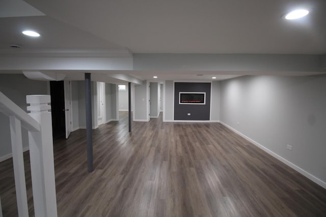 basement with dark hardwood / wood-style floors and a fireplace