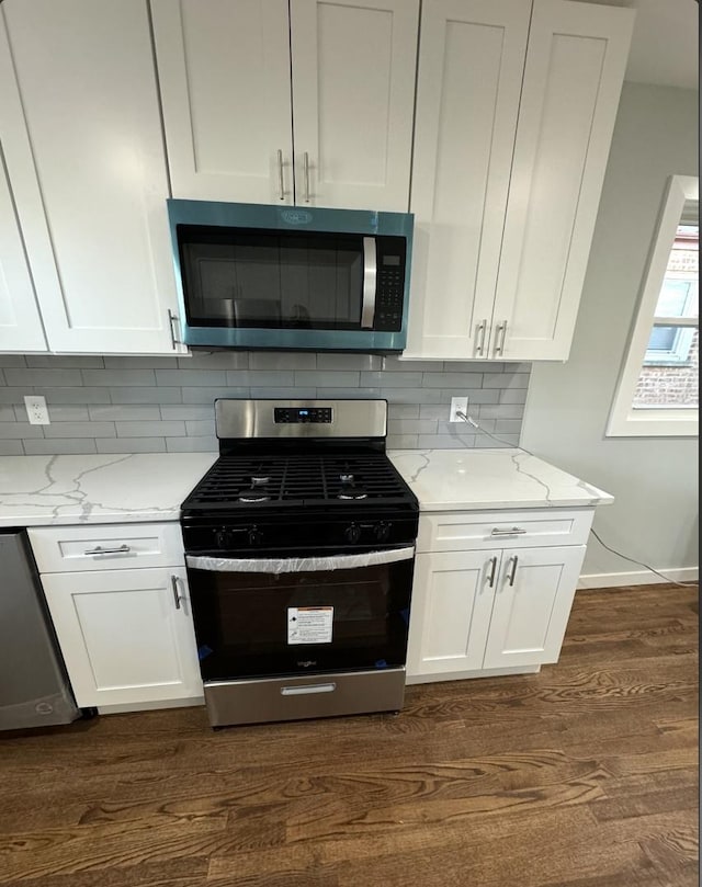 kitchen featuring light stone counters, white cabinets, and appliances with stainless steel finishes