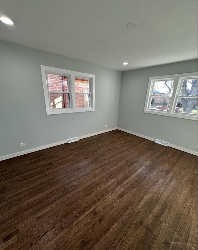 spare room with dark hardwood / wood-style floors