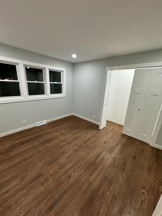 empty room featuring dark wood-type flooring