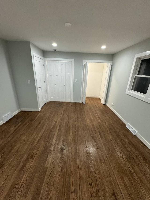 unfurnished bedroom featuring dark hardwood / wood-style flooring