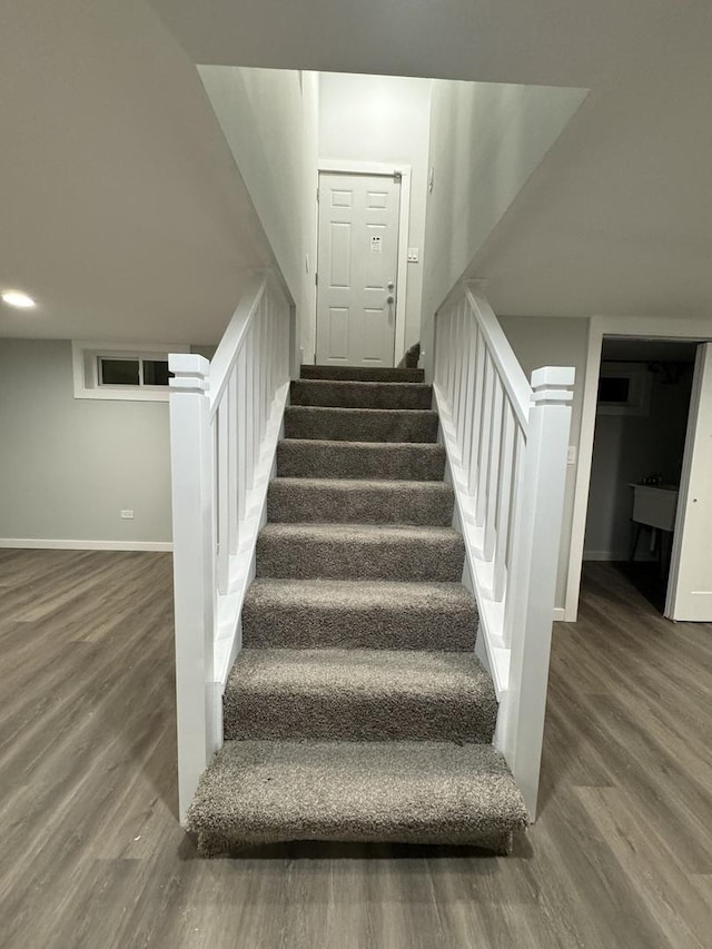 staircase with hardwood / wood-style flooring