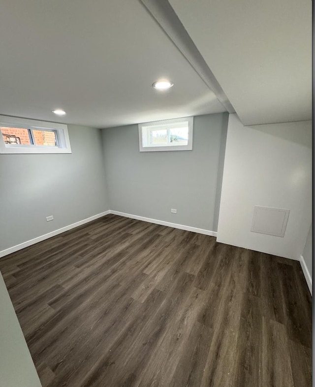 basement with dark hardwood / wood-style flooring