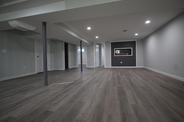 basement with dark hardwood / wood-style flooring