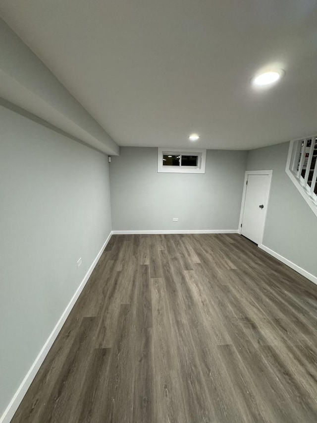 basement with dark hardwood / wood-style floors