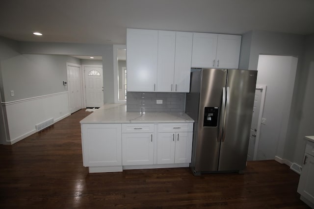 kitchen with white cabinets, stainless steel fridge with ice dispenser, and light stone countertops