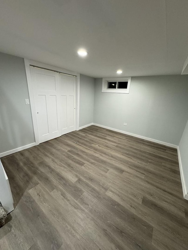 basement featuring dark hardwood / wood-style flooring