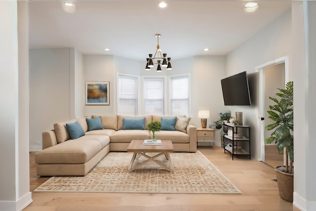 living room featuring light hardwood / wood-style flooring and a notable chandelier