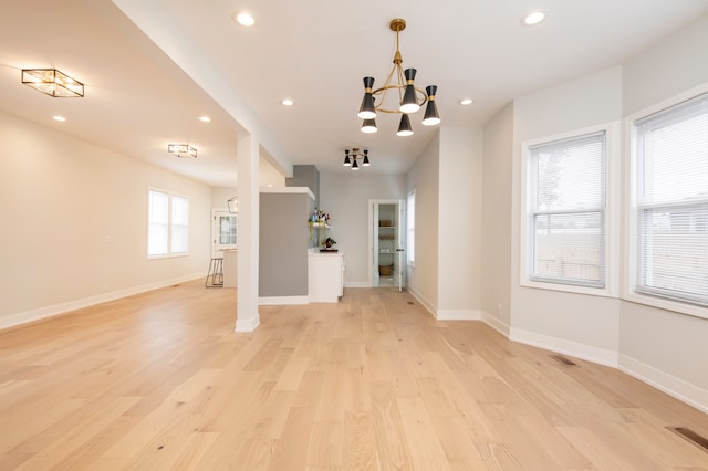 interior space featuring light hardwood / wood-style floors and a notable chandelier